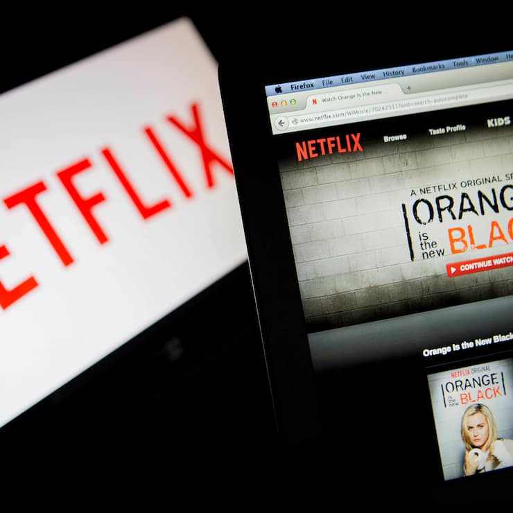 The Netflix Inc. website displays the "Orange is the New Black" series on a laptop computer in this arranged photograph in Washington, D.C., U.S., on Thursday, July 10, 2014. "House of Cards," and "Orange Is the New Black," two Netflix Inc. series that have boosted the popularity of online viewing, will compete for television's top honors as nominees for Emmy awards in drama and comedy. Photographer: Andrew Harrer/Bloomberg via Getty Images