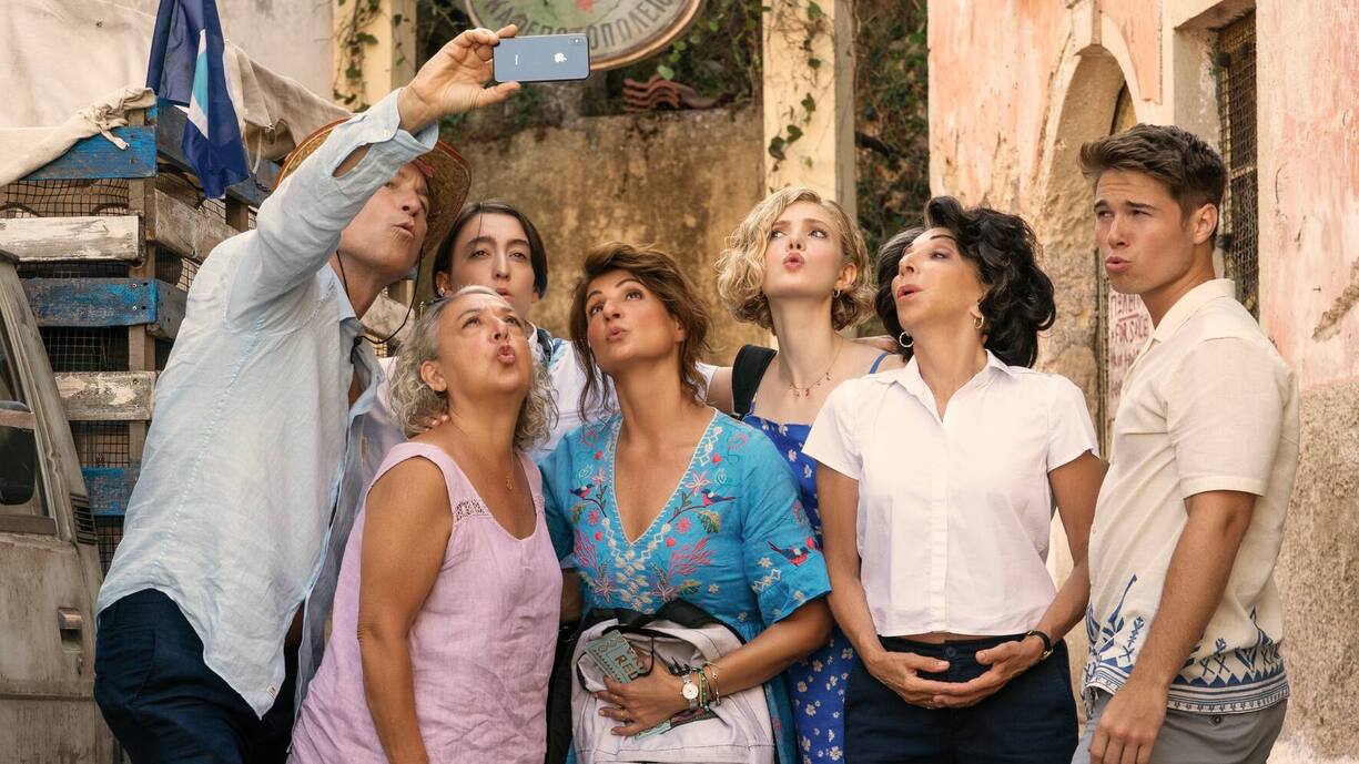 (L to R) John Corbett as "Ian", Maria Vacratsis as "Aunt Frieda", Melina Kotselou as "Victory", Nia Vardalos as "Toula", Elena Kampouris as "Paris", Andrea Martin as "Aunt Voula", and Elias Kacavas as "Aristotle" in director Nia Vardalos' MY BIG FAT GREEK WEDDING 3, a Focus Features release. Courtesy of Yannis Drakoulidis / Focus Features